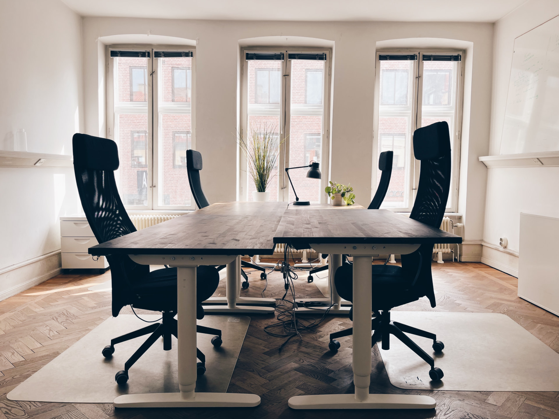 Office room with herringbone parquet floor and tall windows
